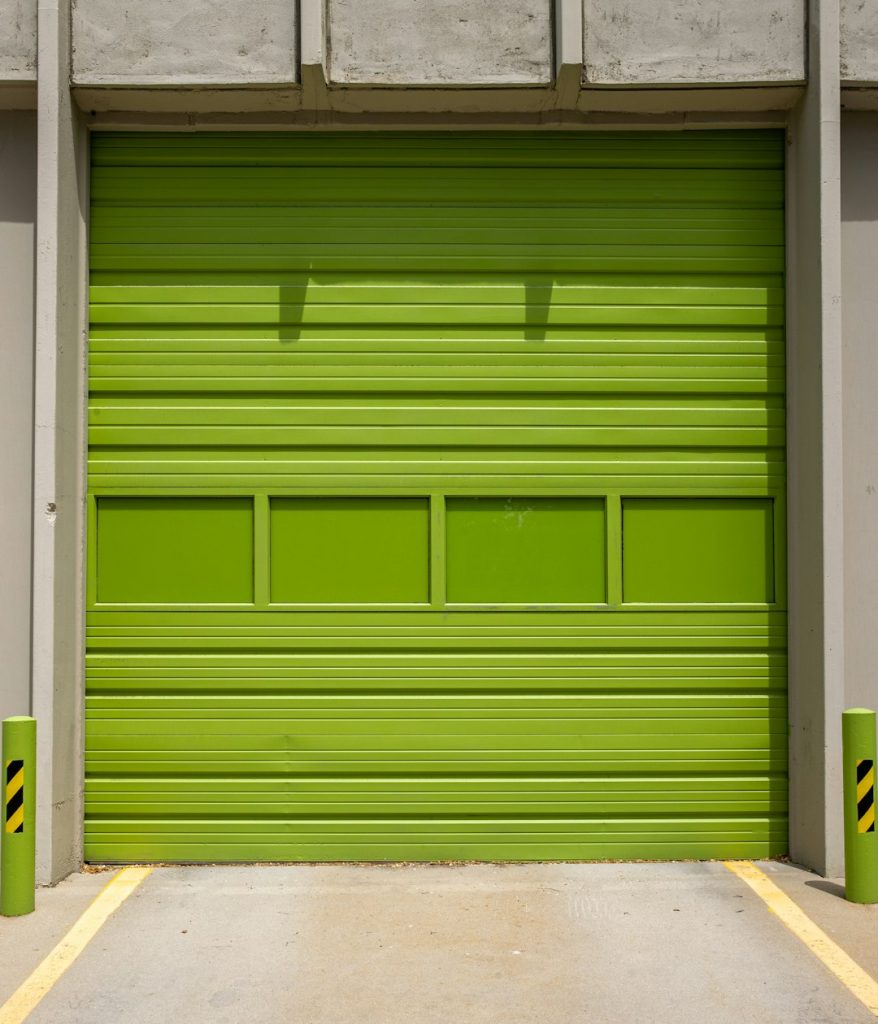 green-wooden-door-on-gray-concrete-floor-ga7abzn7qdw